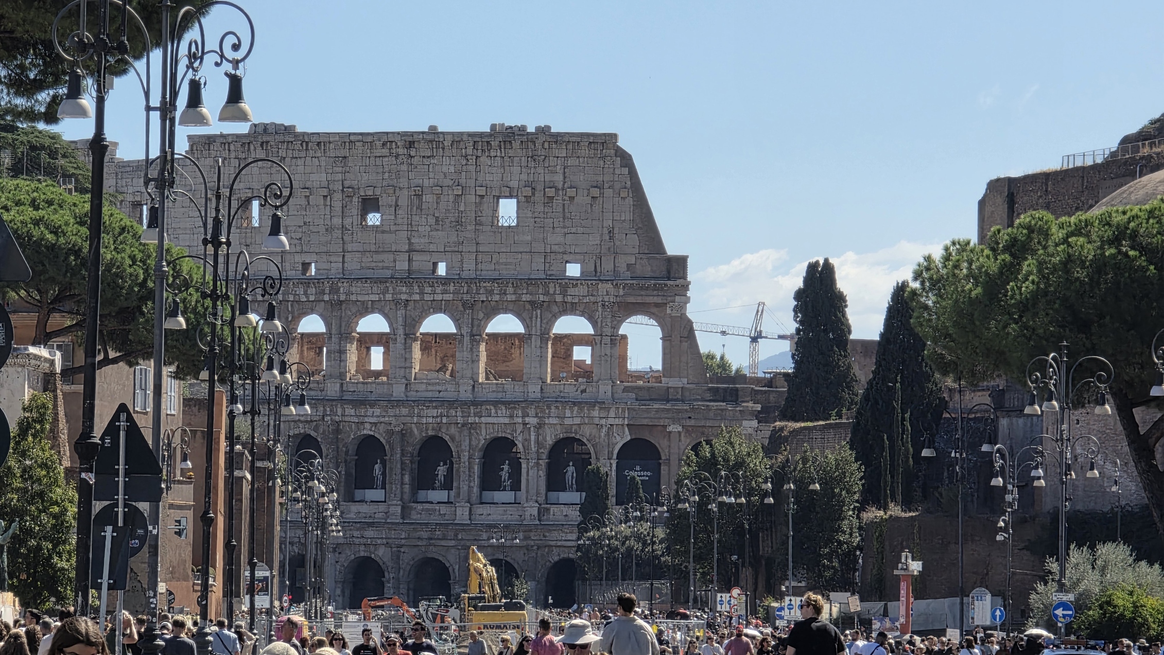 The Colosseum seen down the avenue in afternoon light