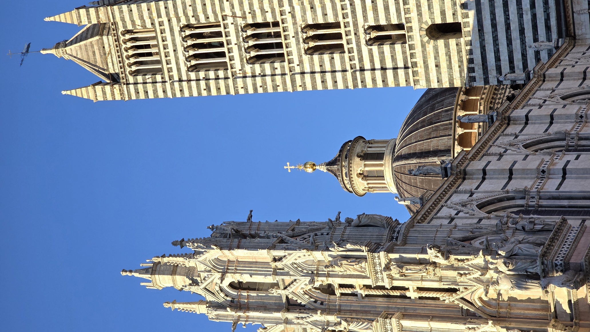 The striped marble campanile and dome of Siena Cathedral