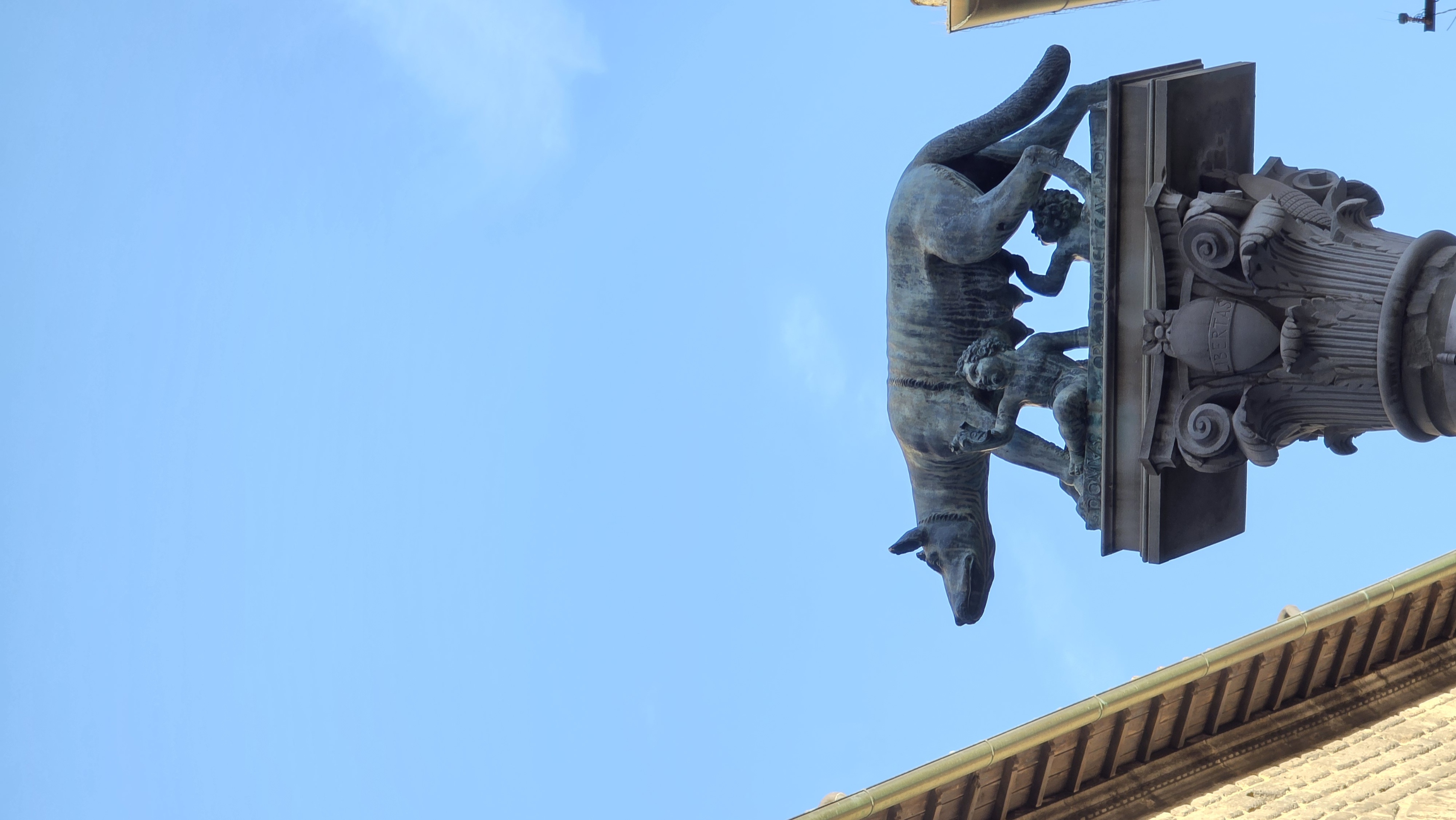 The she-wolf of Siena on her column, silhouetted against the sky