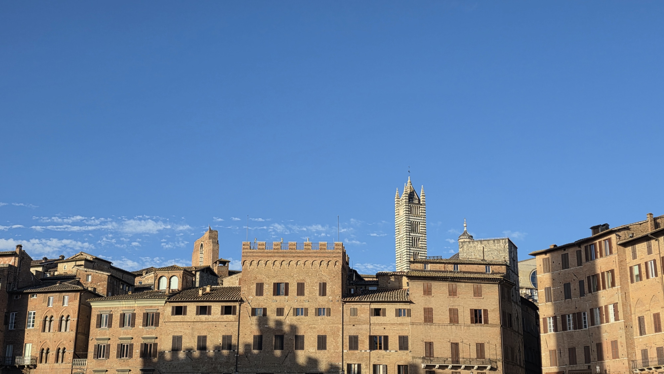 Panorama of Siena rooftops and towers under a wide sky