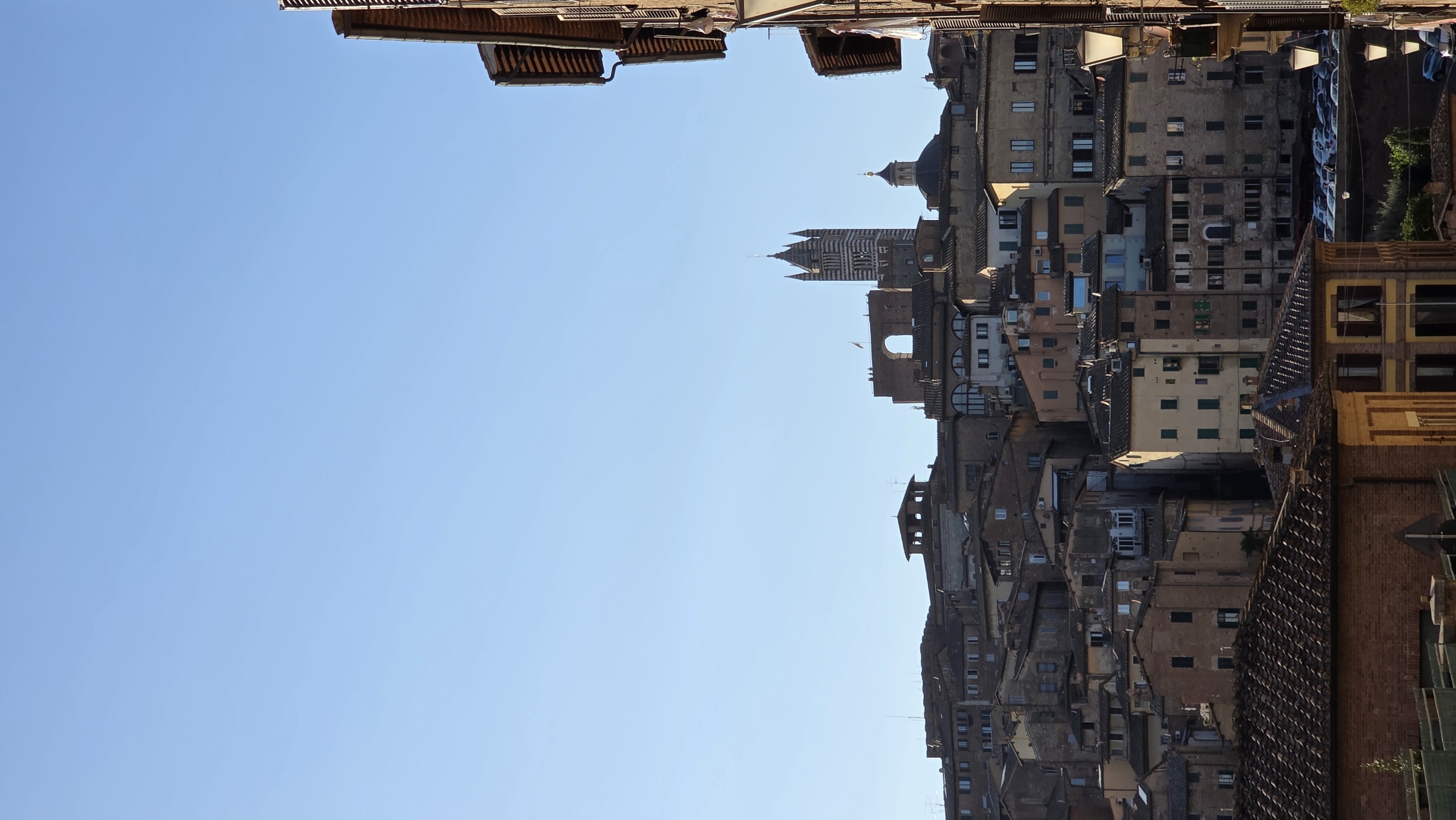 The town rising toward the cathedral, seen across terracotta roofs