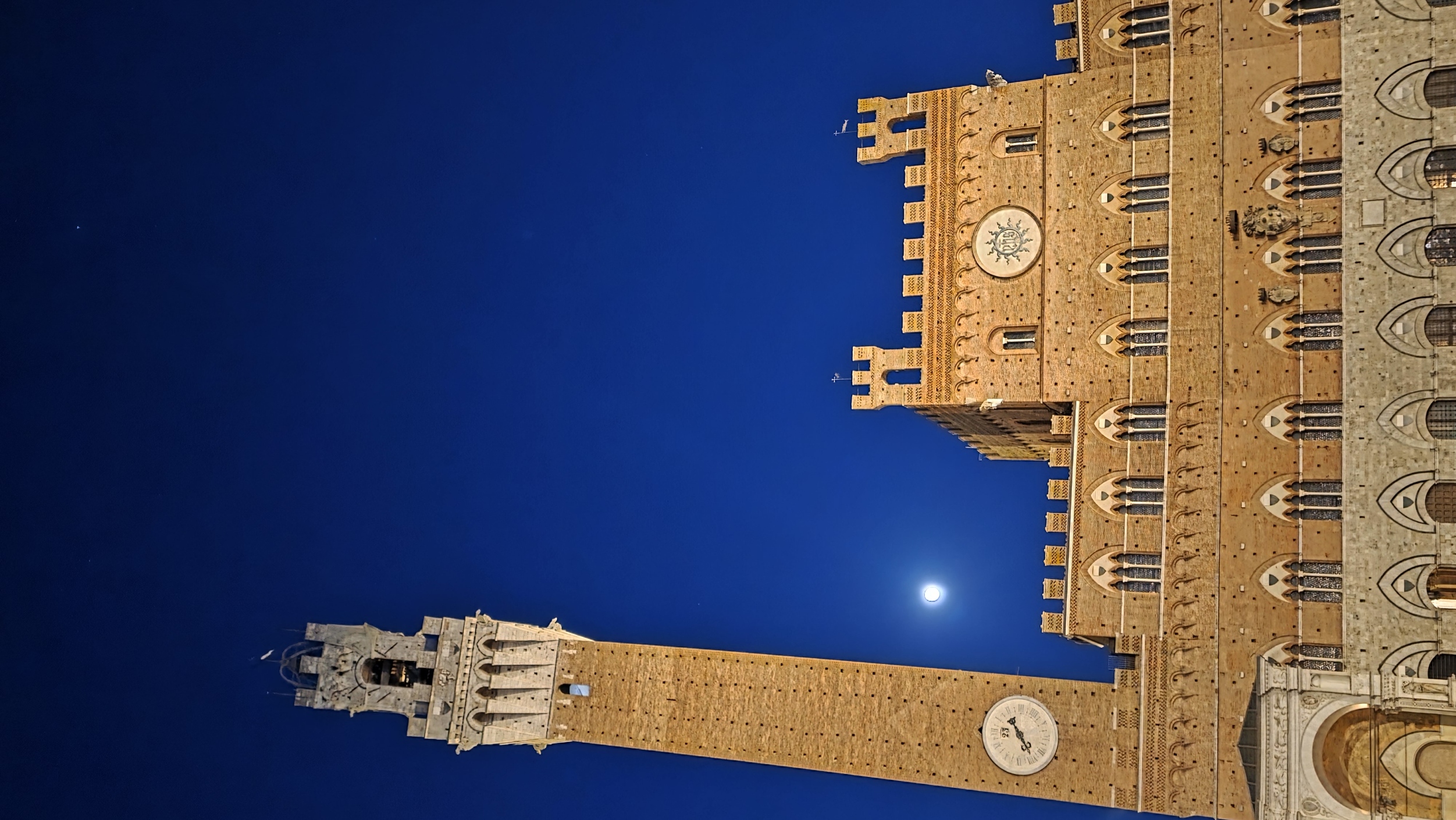 The Torre del Mangia and the Palazzo Pubblico at blue hour with the moon